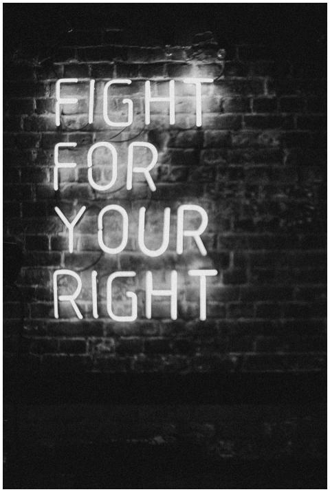 Monochrome neon sign on brick wall with slogan 'Fi