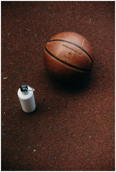 Close-up of a basketball and a water bottle on a t
