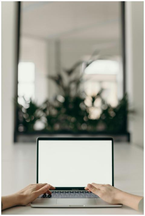 A minimalist workspace featuring an open laptop in