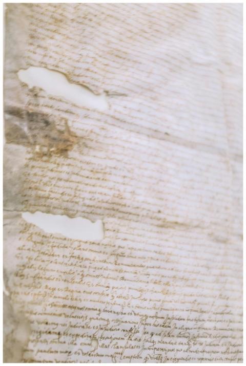 Old shabby handwritten manuscript on dirty torn pa