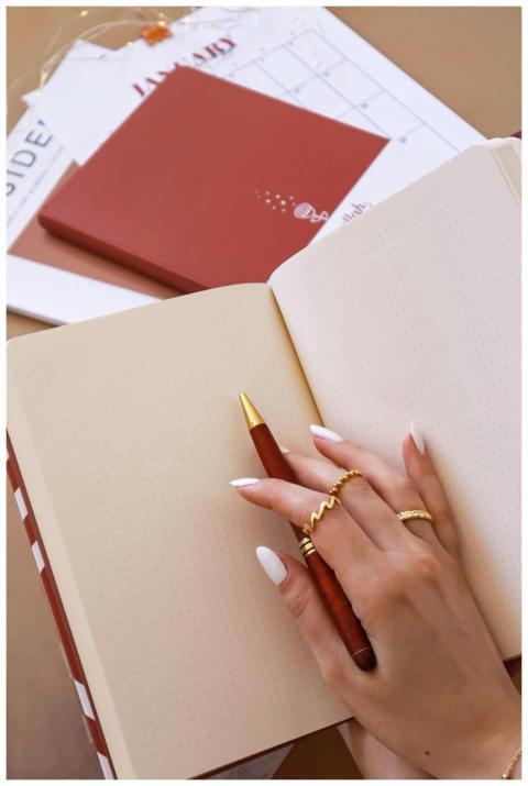 Close-up of a hand with manicured nails holding a