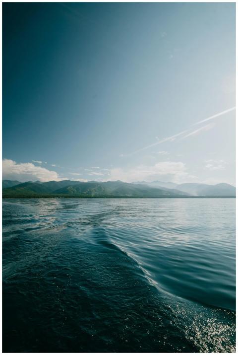 A tranquil seascape featuring calm waters, distant