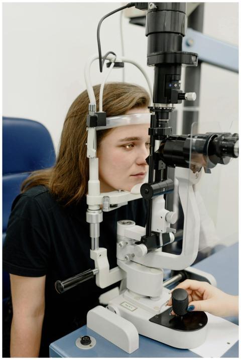 A young woman receives an eye examination using mo