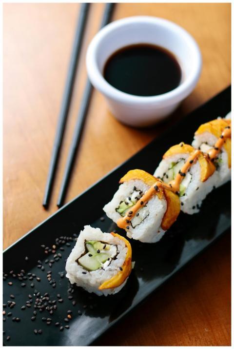 Close-up of sushi roll with soy sauce, perfect for