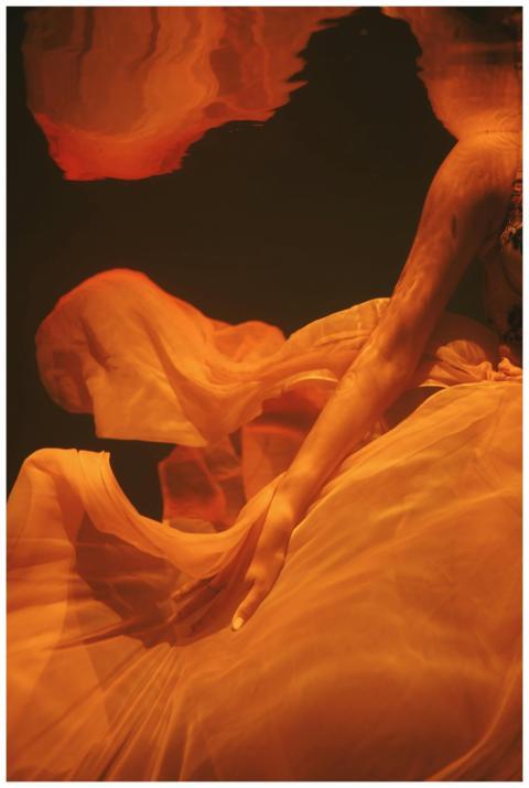 A mysterious underwater scene with flowing fabric