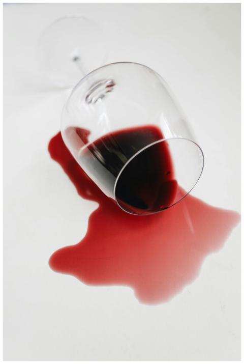 A spilled glass of red wine artfully displayed on