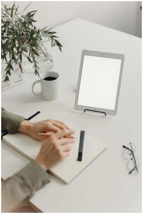 Minimalist home office setup with tablet, notebook