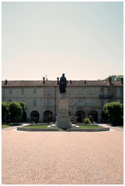 A statue stands in front of a historic building in