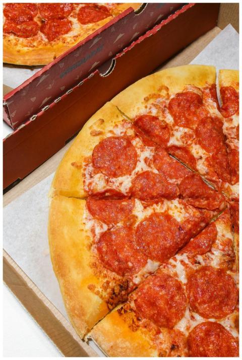 Mouthwatering pepperoni pizza in a cardboard box,
