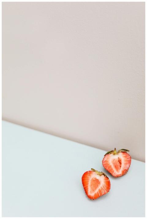 A close-up of two halved strawberries placed on a