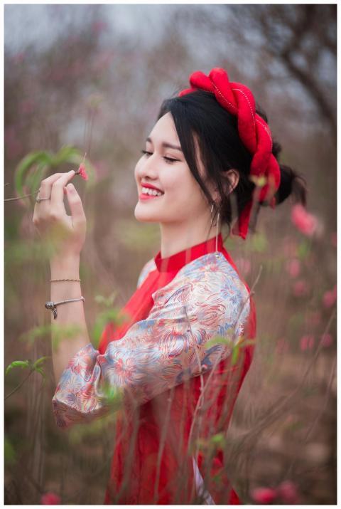 Smiling young woman in traditional dress enjoying
