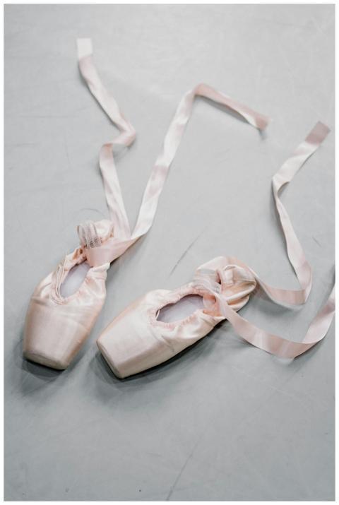 From above of white shoes for ballerina with silk