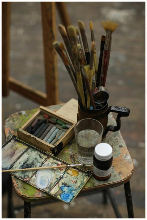 Close-up of art supplies on a wooden stool, perfec
