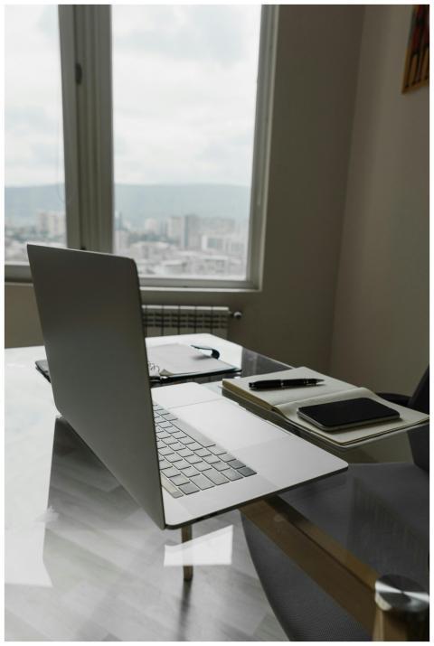 A sleek home office setup with a laptop and city v