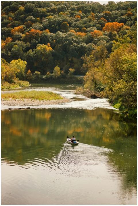 A kayaker enjoys a peaceful paddle on a scenic riv