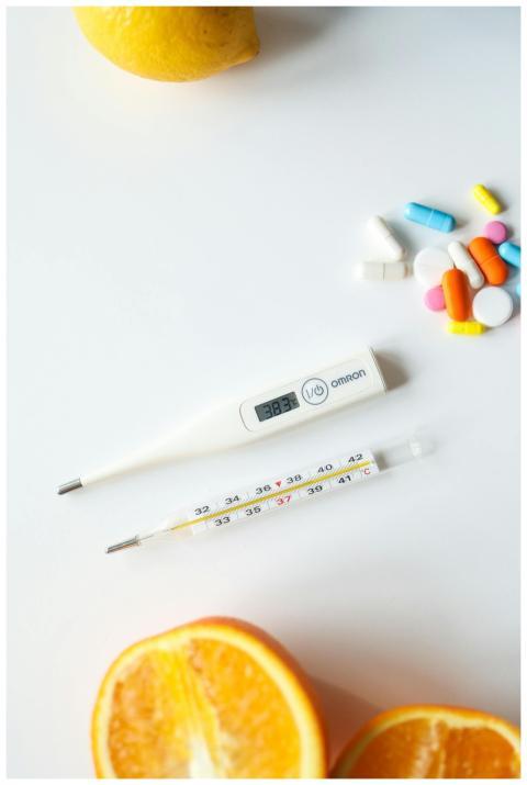 Digital and mercury thermometers with colorful pil