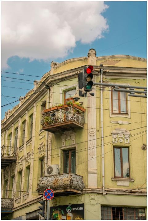 Vintage building facade with balcony and street li