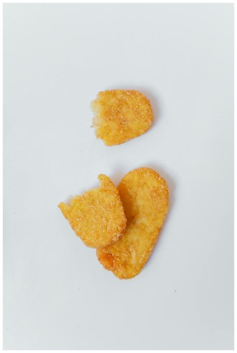 Three golden brown hash browns neatly arranged on