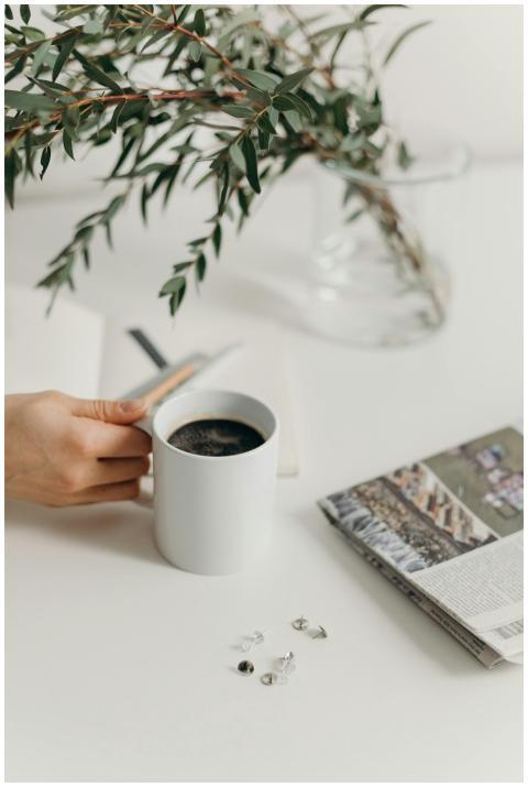 A clean and serene workspace with a white mug of c