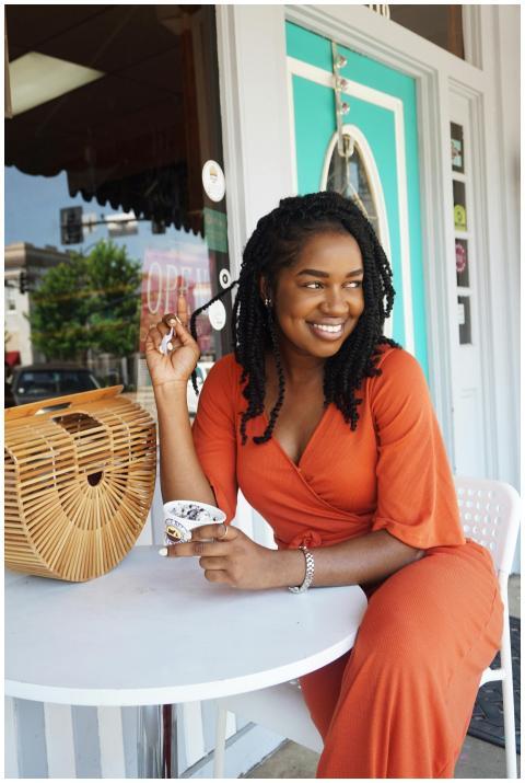 Stylish woman in orange outfit enjoying ice cream