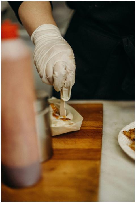 Chef prepares Korean street food with precision, h
