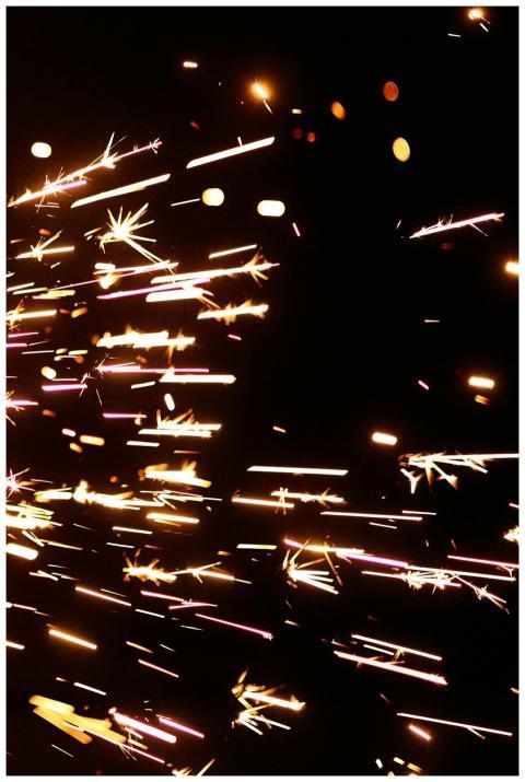 Energetic spark trails streaking across a dark bac