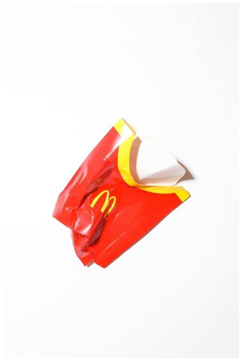 Crumpled red fast food packaging isolated on a whi