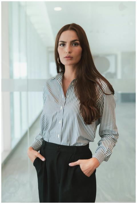 Businesswoman with brown hair in a striped shirt s