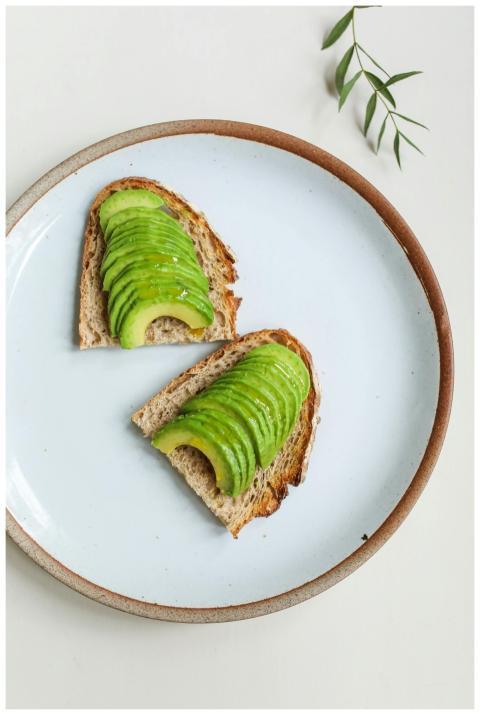 Minimalist image of sliced avocado on toast, ideal