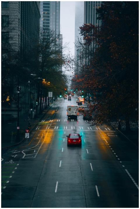 A rainy Seattle street with glowing lights at twil