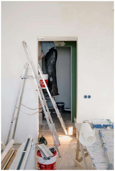 Indoor scene of home renovation with ladders, tool
