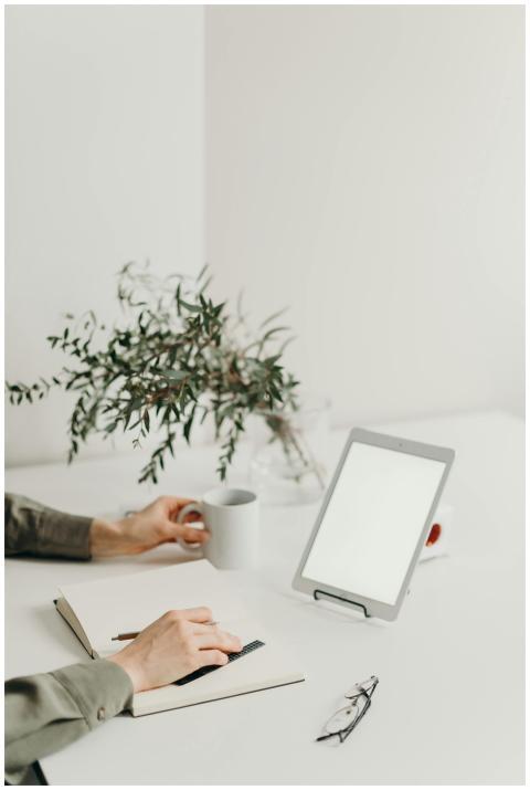 A minimalist home office setup with a blank screen