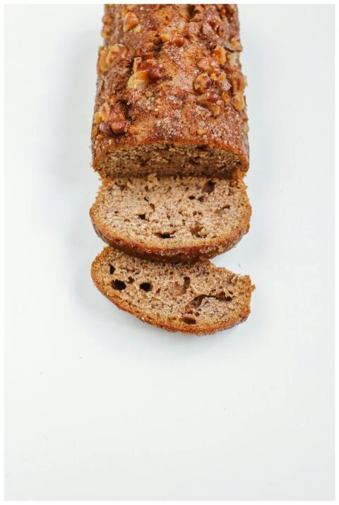 Close-up of sliced banana bread on a white surface