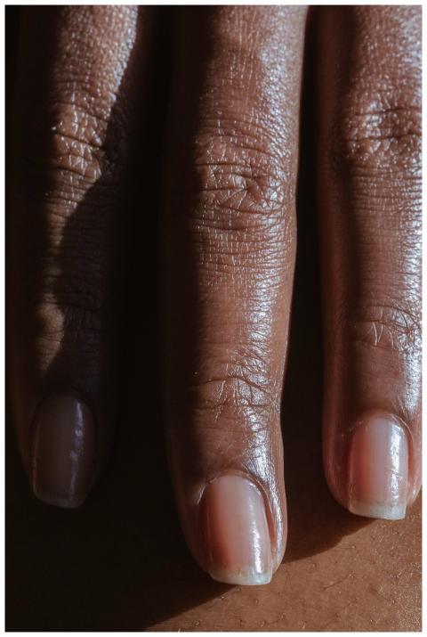 Hand with long fingers with nails of crop anonymou