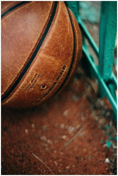 Detailed view of a leather basketball resting agai
