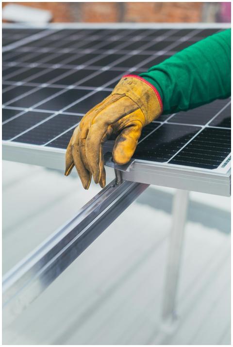 Close-up of a worker's hand in protective glove in
