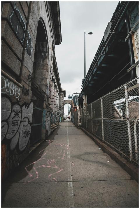 A gritty city alley in New York City with graffiti