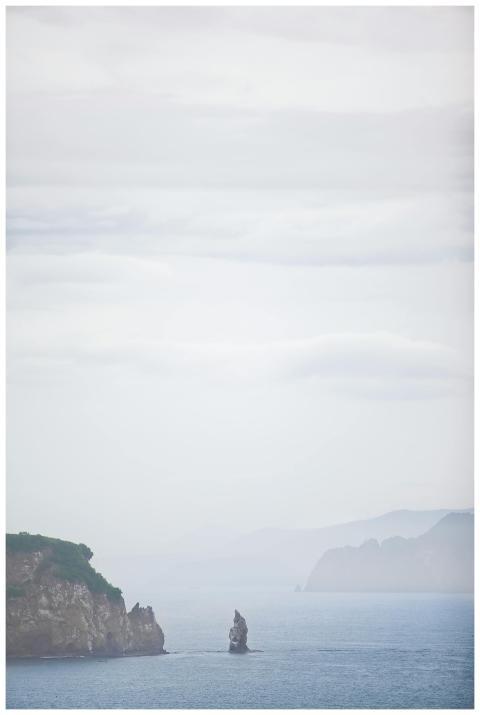 Peaceful seascape with cliffs and sea in soft dawn