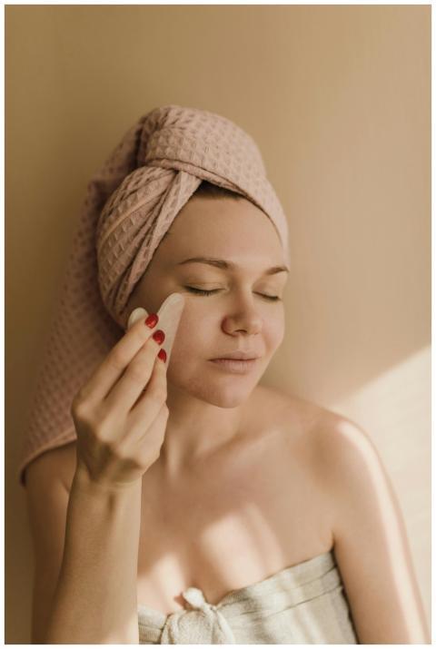 A woman enjoys a relaxing facial treatment using a