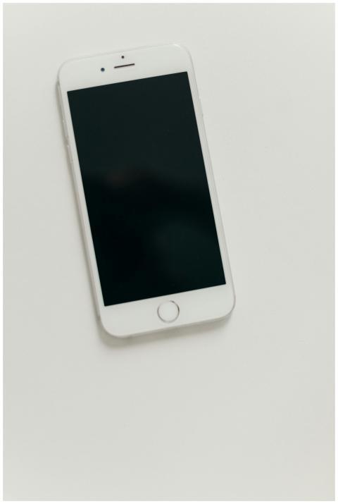 A minimalist flat lay of a smartphone with a blank