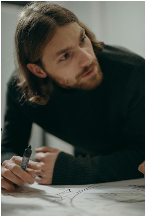 Man with beard and long hair concentrating while w