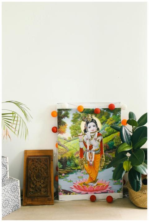 Artistic Krishna poster with string lights, wood c