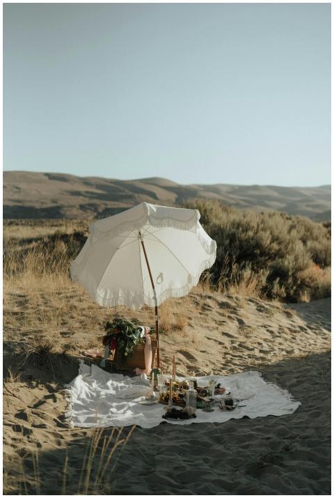 A picturesque boho picnic setup with a parasol, ex