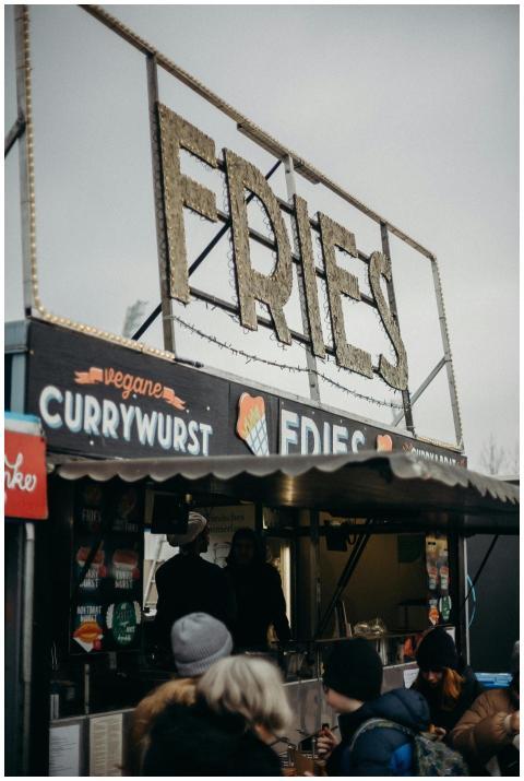 Outdoor street food stall offering fries and vegan