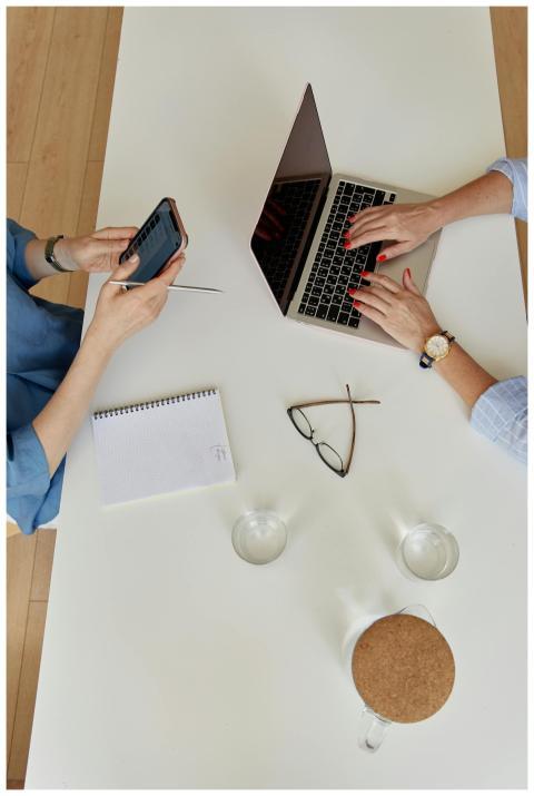 Two businesswomen collaborating in an office with