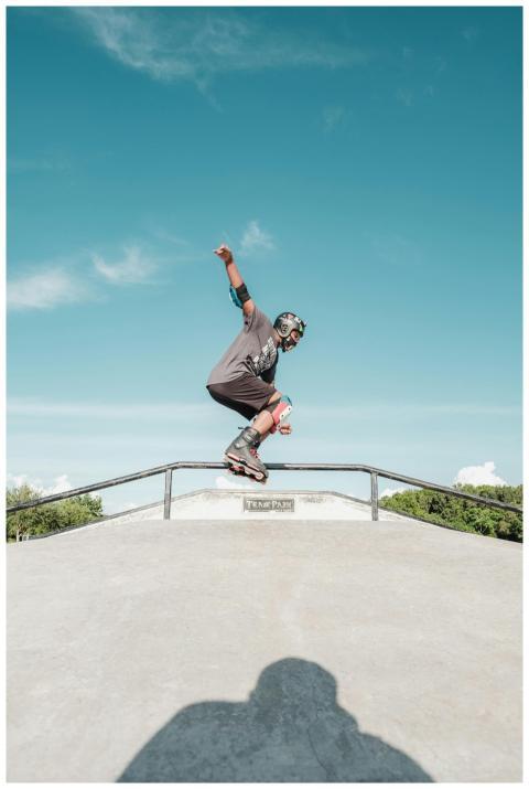 A skater skillfully grinding a rail at an outdoor