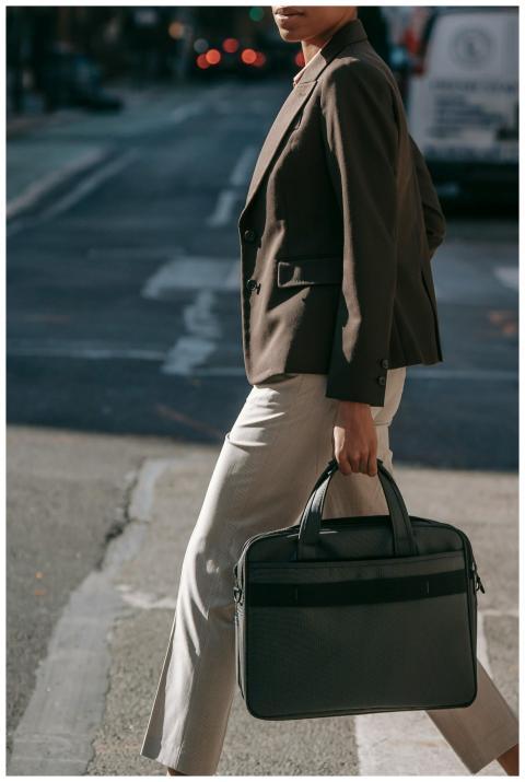 A confident businesswoman crossing a city street,