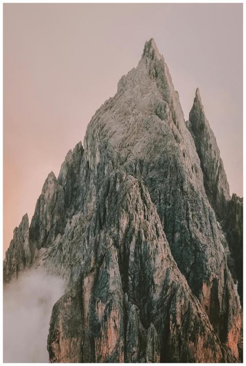 Dramatic mountain peaks emerging from morning mist