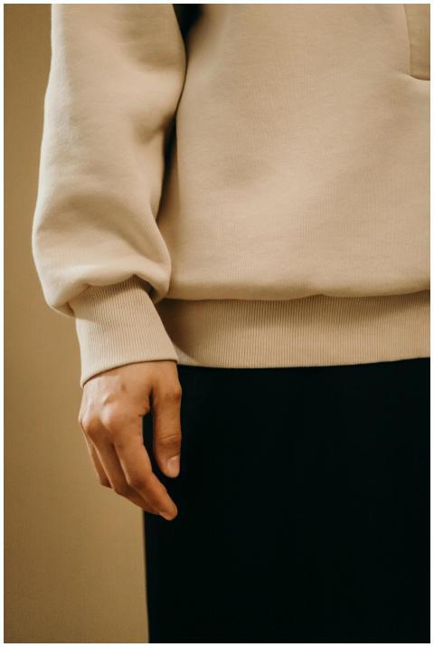 A detailed view of a person wearing a beige sweats