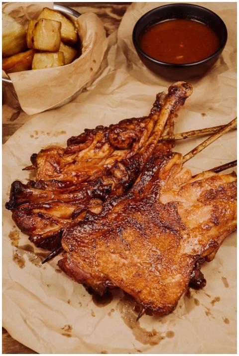 Delicious grilled pork ribs with sauce and fries,